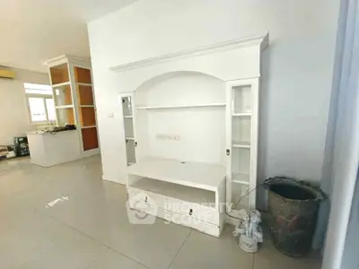 Spacious living room with built-in white entertainment unit and modern decor