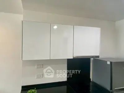 Modern kitchen with sleek white cabinets and stainless steel appliances