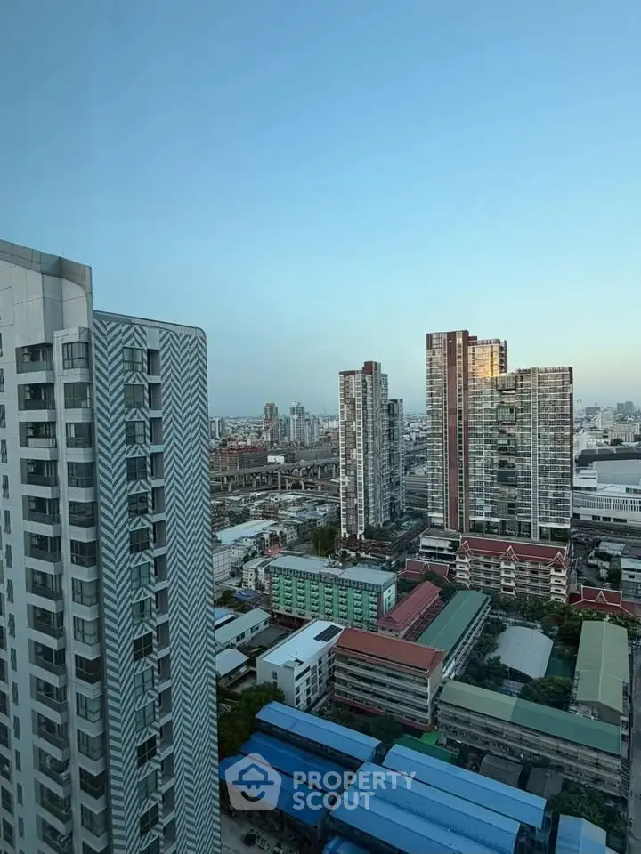 Stunning cityscape view from high-rise apartment showcasing modern urban living.