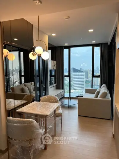 Modern living room with panoramic city view, stylish furniture, and elegant lighting in a high-rise apartment.