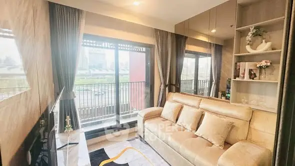 Stylish living room with large windows and modern decor in a high-rise apartment.