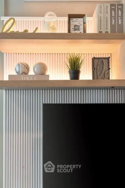Stylish modern living room with decorative shelves and sleek TV setup.