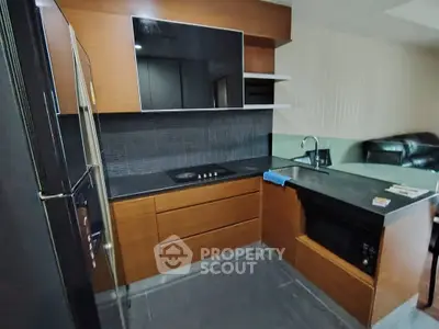 Modern kitchen with sleek cabinetry and built-in appliances in a contemporary apartment.