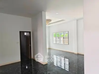 Spacious modern living room with glossy black marble floors and elegant chandelier.