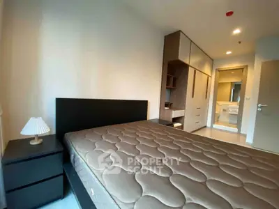 Modern bedroom with sleek furniture and ample storage space