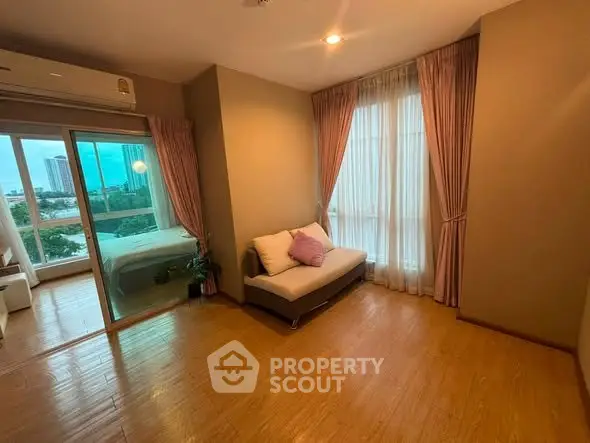 Spacious living room with wooden flooring and large windows in modern apartment