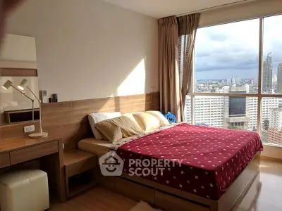 Spacious bedroom with city view in modern high-rise apartment