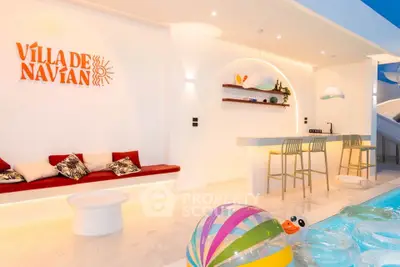 Luxurious modern interior with stylish bar and seating area in Villa de Navián.