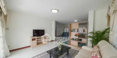 Spacious living room with elegant decor and natural light, perfect for relaxation and entertainment.