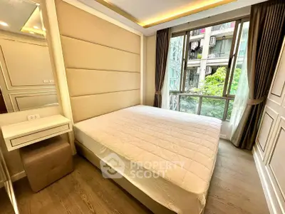 Spacious bedroom with large window and modern decor in a luxury apartment.