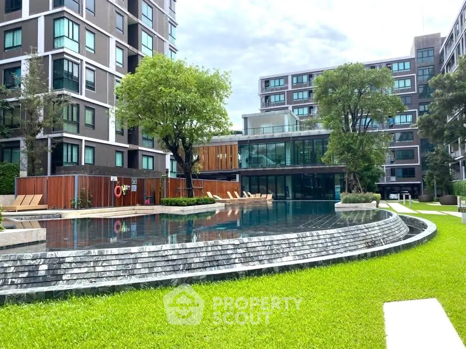 Luxurious residential complex with stunning pool and lush greenery