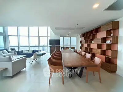Spacious modern living room with panoramic city views and elegant dining area.
