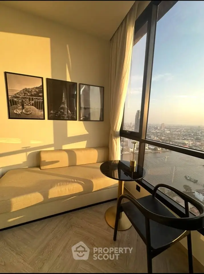 Stunning high-rise apartment with panoramic city view and cozy seating area.