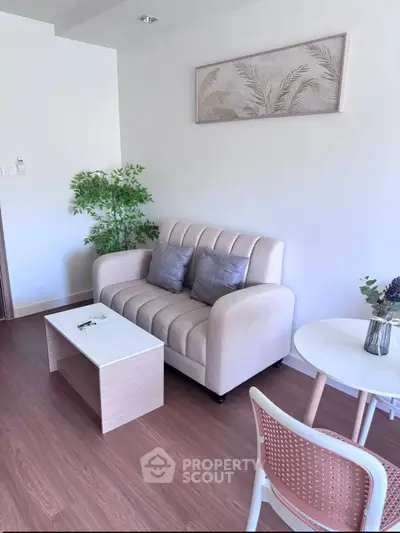 Chic modern living room with cozy beige sofa and stylish decor, perfect for relaxation and entertaining.