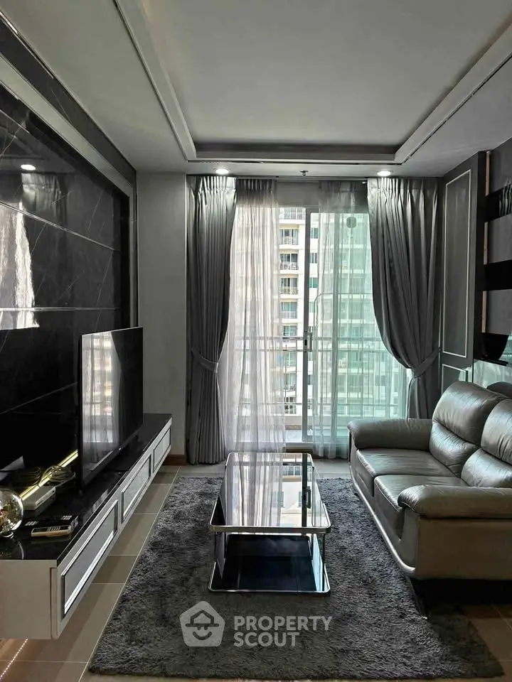 Modern living room with sleek furniture and large window offering city view