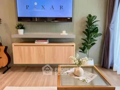 Stylish living room with modern decor and wall-mounted TV, perfect for relaxation and entertainment.