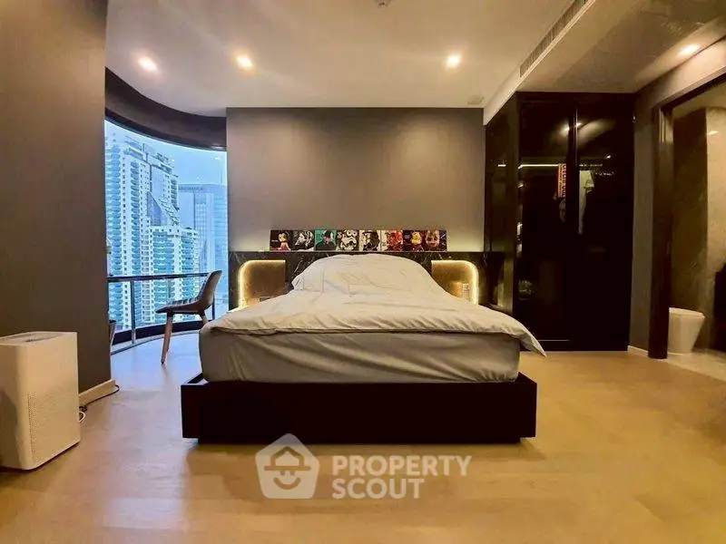 Luxurious bedroom with city view and modern decor, featuring a stylish bed and large windows.