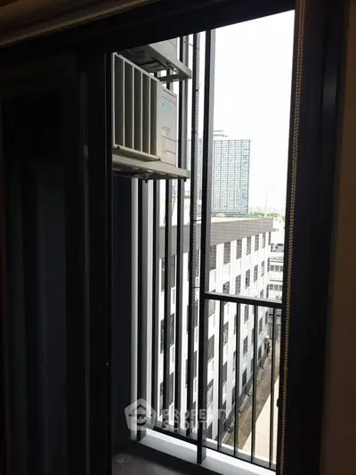 Modern apartment balcony with city view and air conditioning unit.