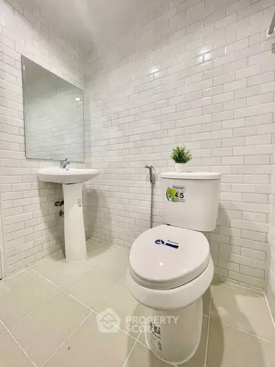 Modern bathroom with white subway tiles and sleek fixtures.