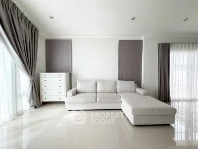 Spacious modern living room with elegant white sofa and natural light