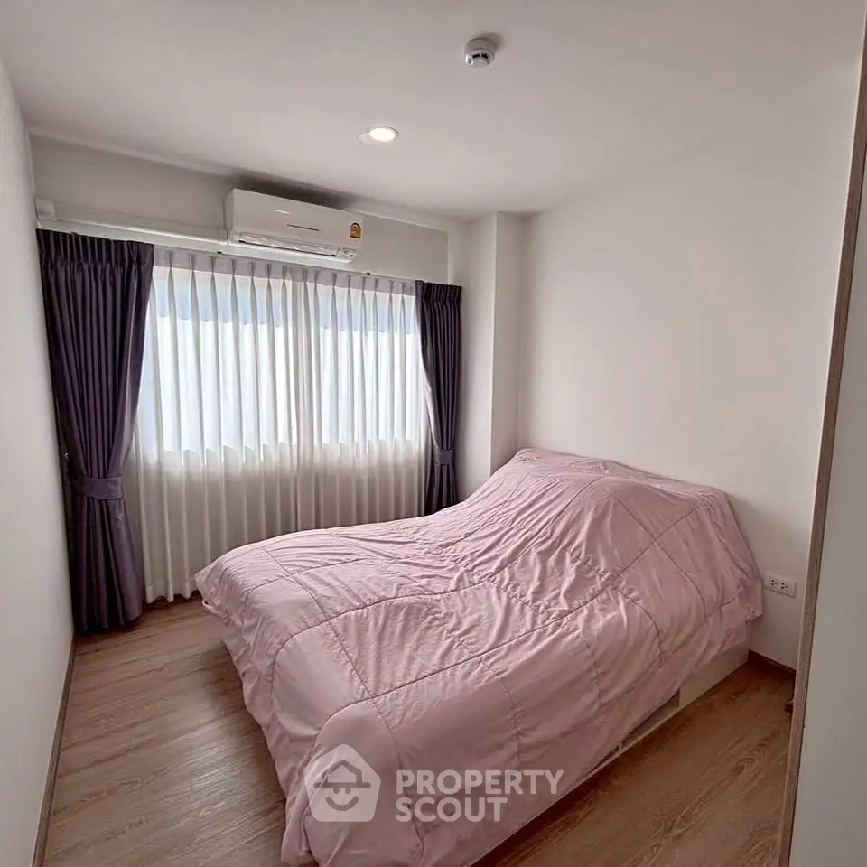Cozy bedroom with natural light and modern decor, featuring a comfortable bed and elegant curtains.