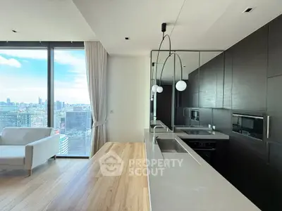 Modern kitchen with sleek design and stunning city view from large windows.