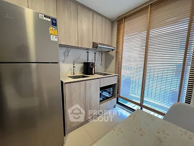 Modern kitchen with stainless steel fridge and open layout design.