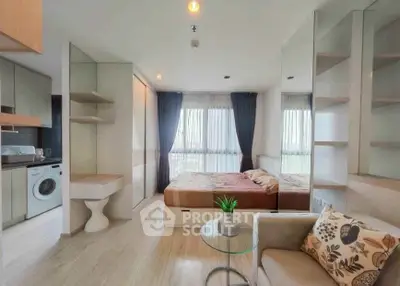 Modern studio apartment with open layout, featuring a cozy bed, compact kitchen, and stylish decor.