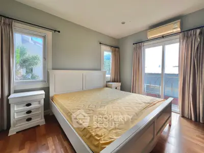 Spacious bedroom with large windows and air conditioning in modern home