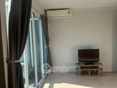 Bright living room with sliding glass doors and air conditioning unit.