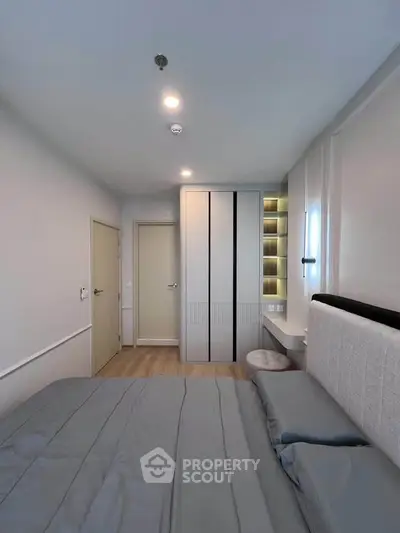 Modern bedroom with sleek wardrobe and cozy bed in stylish apartment