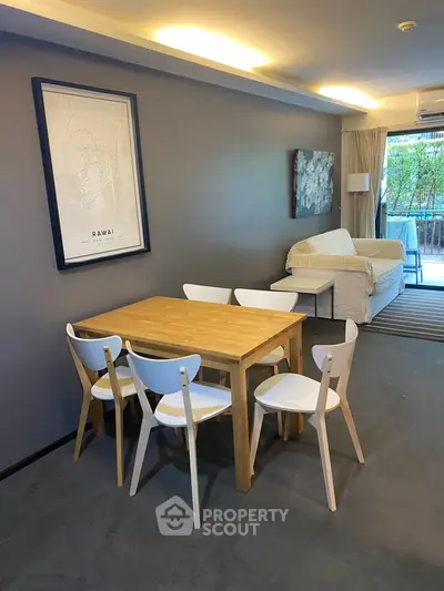 Stylish living room with modern dining set and cozy sofa, perfect for relaxation and entertaining.