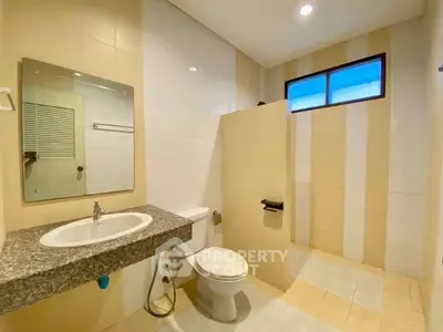 Spacious modern bathroom with elegant fixtures and natural light.