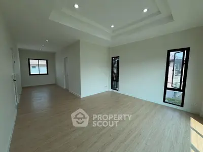 Spacious modern living room with elegant ceiling design and large windows