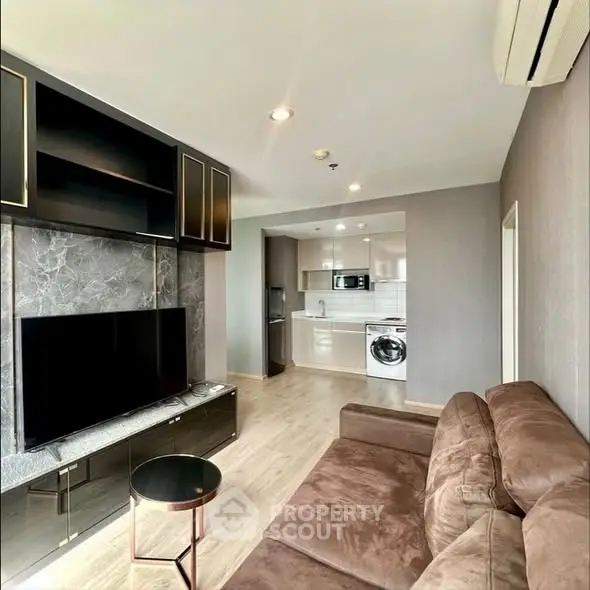 Modern living room with sleek furniture and open kitchen layout