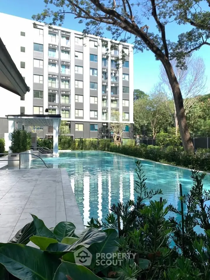 Luxurious apartment complex with a stunning outdoor pool and lush greenery, perfect for relaxation and leisure.