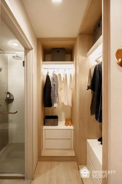 Modern walk-in closet with stylish lighting and ample storage space