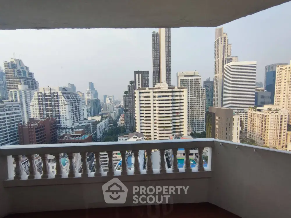 Stunning cityscape view from a high-rise balcony in urban setting.
