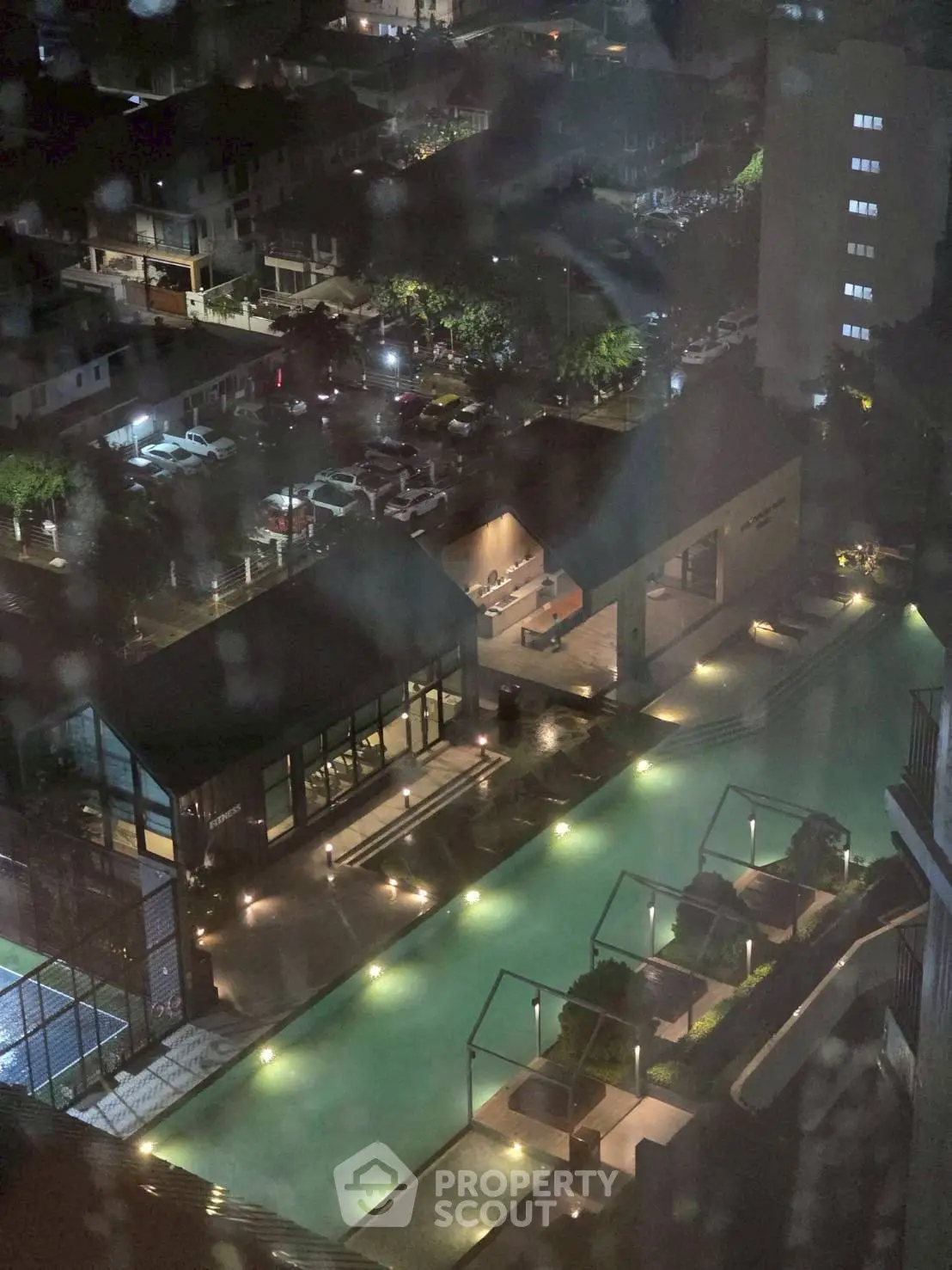 Stunning night view of illuminated pool area in modern residential complex.