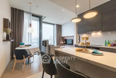 Modern open-layout kitchen and living area with stylish decor and city view.