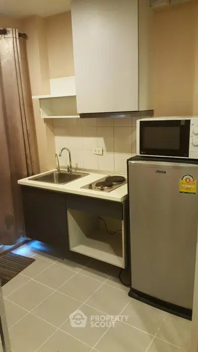 Compact kitchen with modern appliances and sleek design