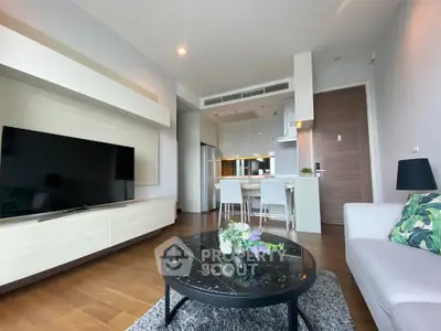 Modern living room with sleek furniture and open kitchen layout