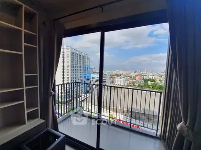 Stunning city view from modern apartment balcony with sliding glass doors.