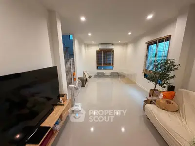 Spacious modern living room with sleek design and ample natural light, perfect for relaxation and entertainment.