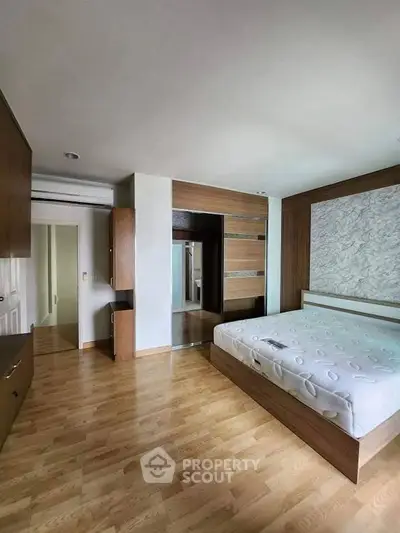 Spacious bedroom with modern design and wooden flooring