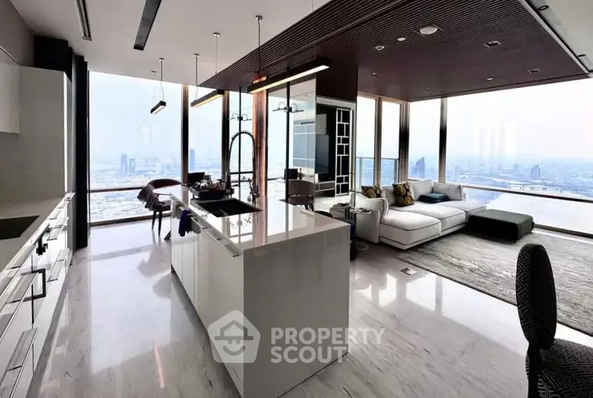 Luxurious modern living room with panoramic city views and sleek open kitchen design.