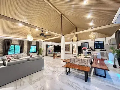 Spacious open-plan living and dining area with modern decor and high ceilings