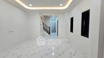 Spacious modern interior with elegant marble flooring and recessed lighting, perfect for stylish living.