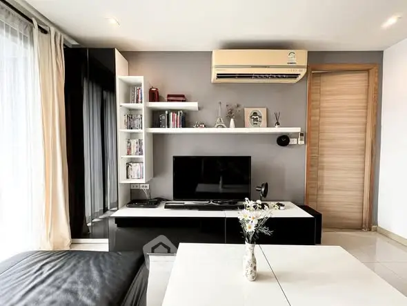Modern living room with sleek entertainment center and air conditioning unit.