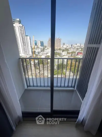 Stunning city view from modern apartment balcony with sleek railing design.